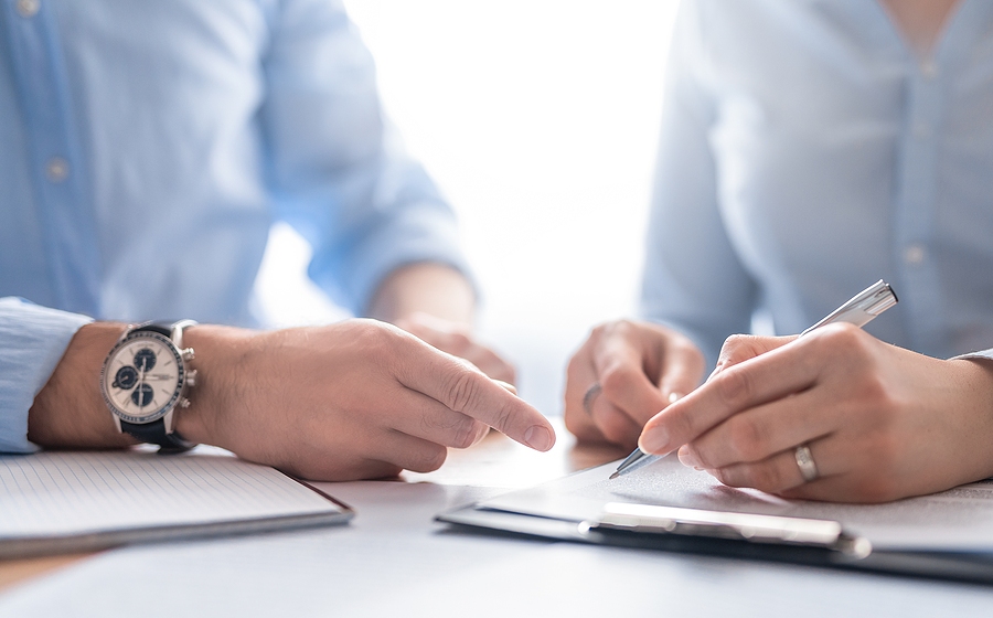 Business professionals negotiating a deal in a corporate office meeting setting