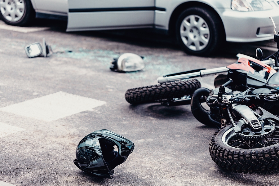 Motorcycle parked with helmet placed on seat beside road
