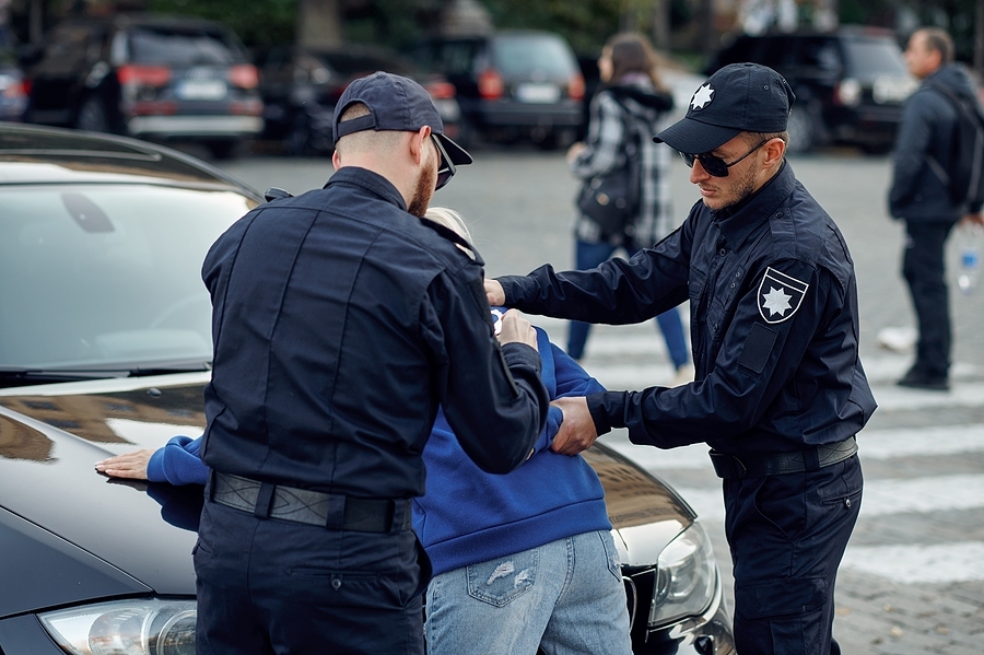 Police officer using excessive force against a civilian during an arrest, illustrating police brutality and misconduct