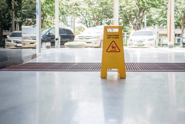 A sign to warn of slippery floors to avoid a slip and fall accident in Kansas City, MO