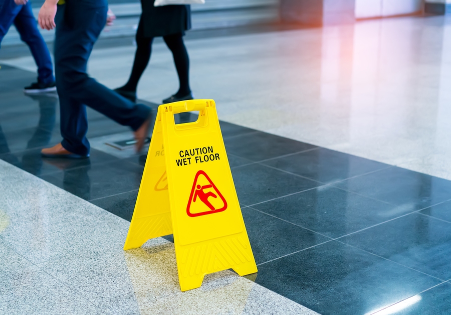 Yellow caution wet floor sign warning of slippery surface hazard in public area