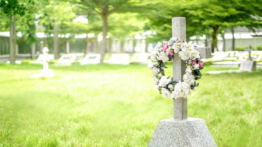 Gravestone in a quiet cemetery representing death, loss, and remembrance