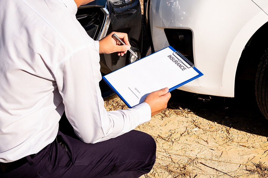 Car insurance agent assisting a customer
