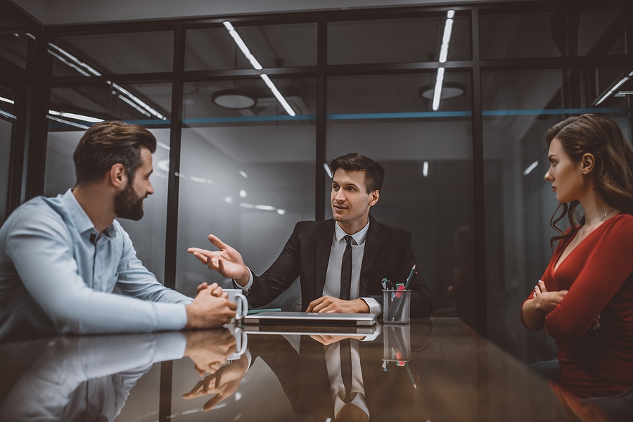Lawyer mediating a dispute between two parties, facilitating negotiation and conflict resolution in an office setting