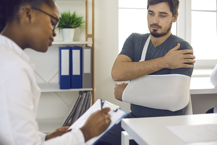 Doctor consulting patient and prescribing treatment during medical appointment