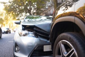 Car accident cases Front-end collision between two vehicles on a city street after a car accident.