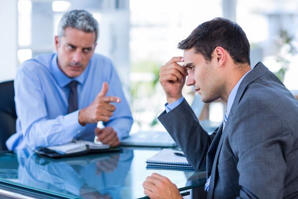 Business colleagues arguing during a tense office meeting, showing workplace conflict and disagreement