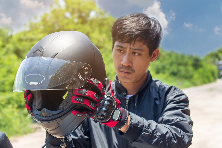 Man Riding Motorcycle with Helmet on Open Road