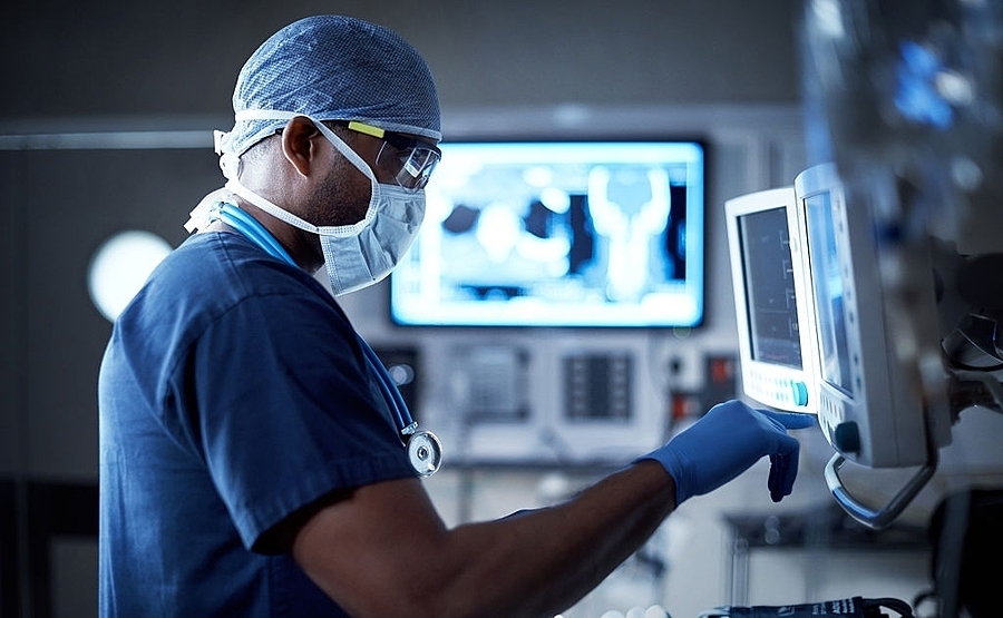 Doctor using stethoscope in hospital with digital healthcare icons representing modern medical technology and patient care