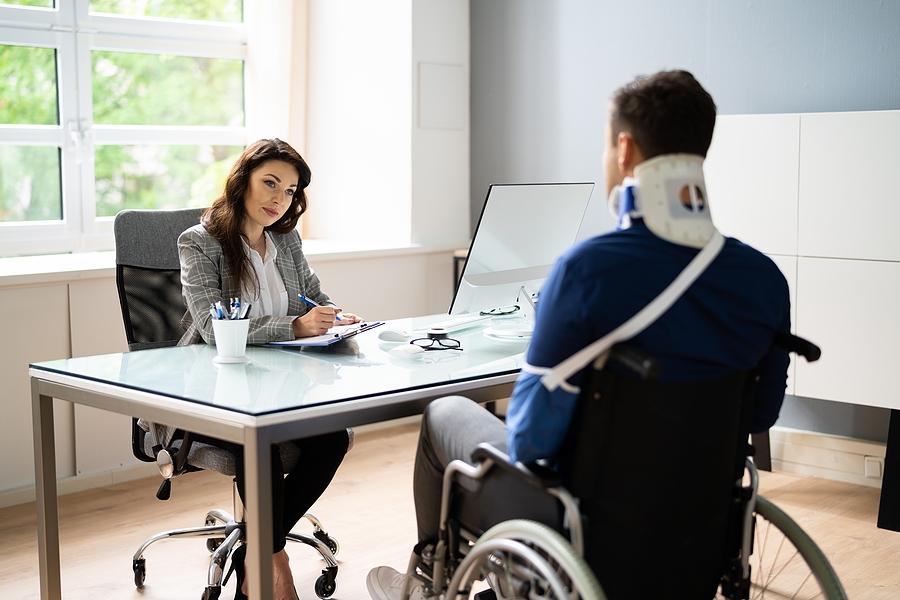 Worker injured on job with disability and car accident insurance concept