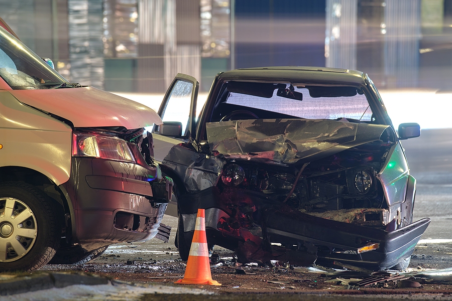 Damaged vehicles and injured individuals at the scene of a road traffic accident