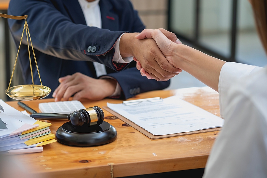 Personal Injury Lawyer Consulting Client in Office