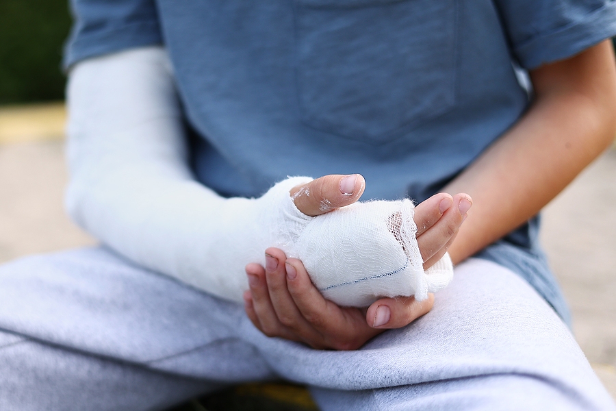 Injured child receiving help after a car accident on the roadside