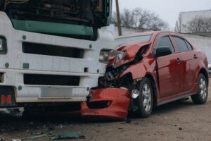 Passenger car heavily damaged after a collision with a commercial truck in Kansas City