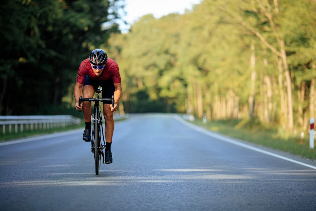 Cyclist Riding on Highway – Kansas City Bicycle Injury Claims Cyclist Riding Fast on Open Road Through Forest