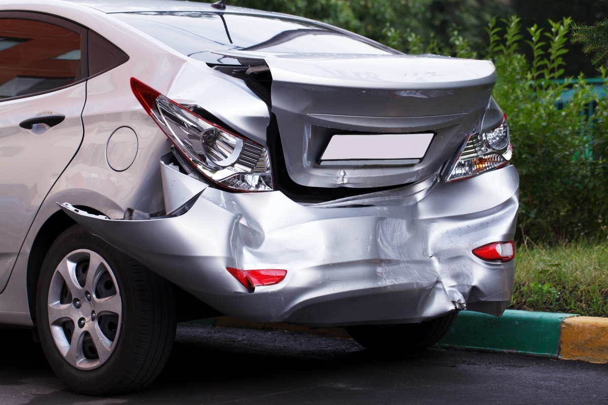 Close-up of large dent on car showing visible damage to vehicle body panel