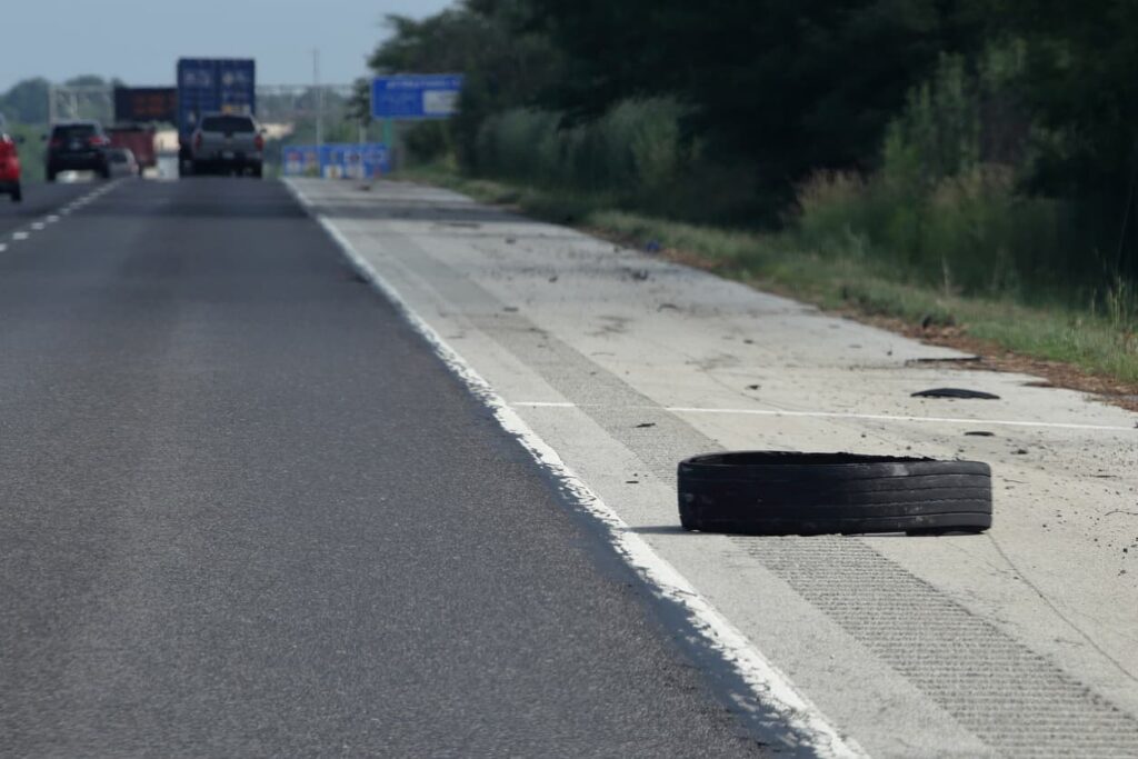 Road Debris Accident in Missouri – Blown Tire Tread Hazard Blown tire tread debris on Missouri highway shoulder causing potential car accident hazard