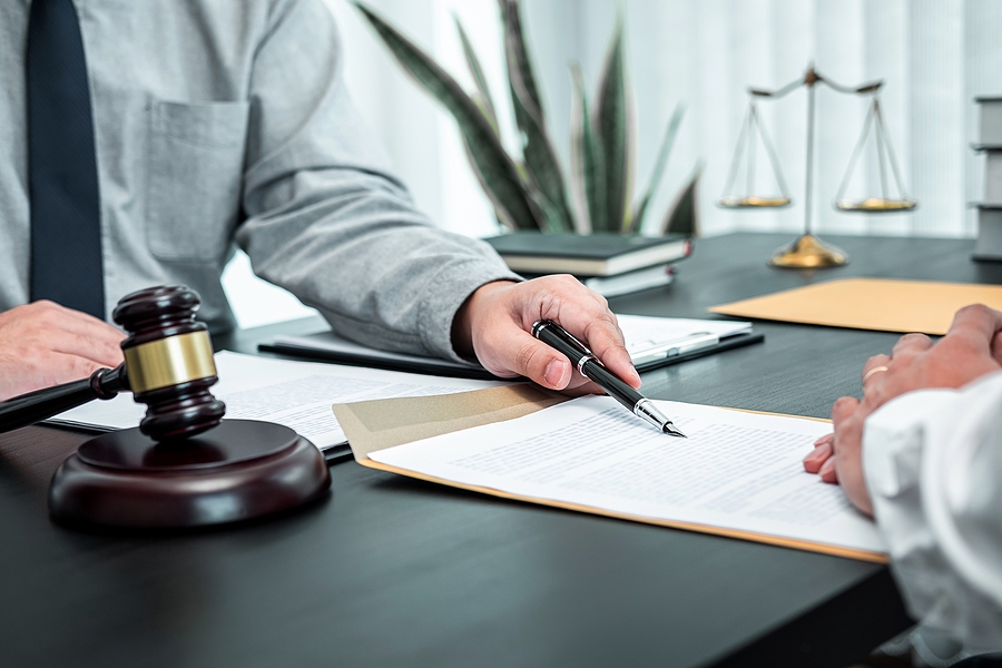 Male lawyer discussing legal case details and negotiating contract terms with a client in an office setting